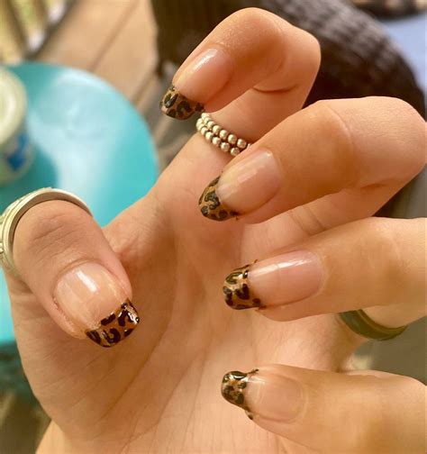 cheetah print french tip nails.